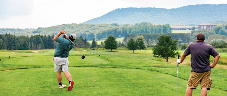 Golfer swinging a club on the course